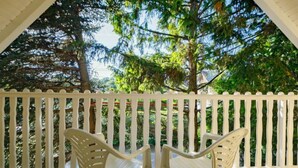 A covered outdoor area with white railings and two plastic chairs. - Captain 2 by Interhome (Siofok)