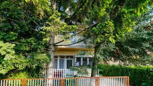 A two-story building with a balcony, surrounded by dense foliage. - Captain 2 by Interhome (Siofok)