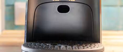 A coffee machine with a sleek black design and a logo on the top.