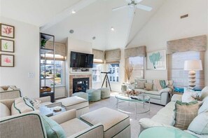 Flat-screen TV, fireplace, books