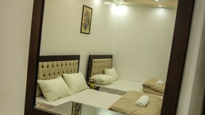 A hotel room with a large mirror, two beds, and a small table. - Queen Pyramids View Inn (Giza)