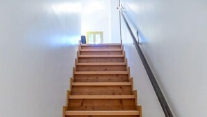 A wooden staircase with a handrail, leading to a door at the top. - Le Chalet Suisse by Interhome (Chamonix)