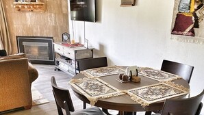 A dining area with a round table, chairs, and a decorative table runner. - Cozy, updated 2 Bedroom / 2 Bathroom condo (Steamboat Springs)