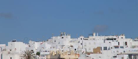 A densely packed urban area with white buildings and a prominent tower-like structure in the foreground.