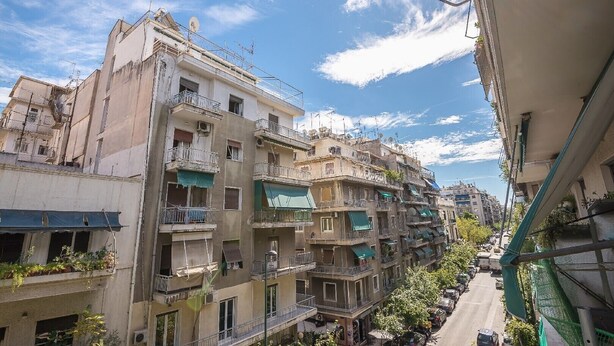 A multi-story residential building with balconies, a street in front, and a clear sky. - Victoria Best Apartments # 3 (Athina)