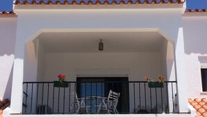 A white building with a balcony, a door, and a window. - Sublime Sun & Van, By Meco Stays (Sesimbra)