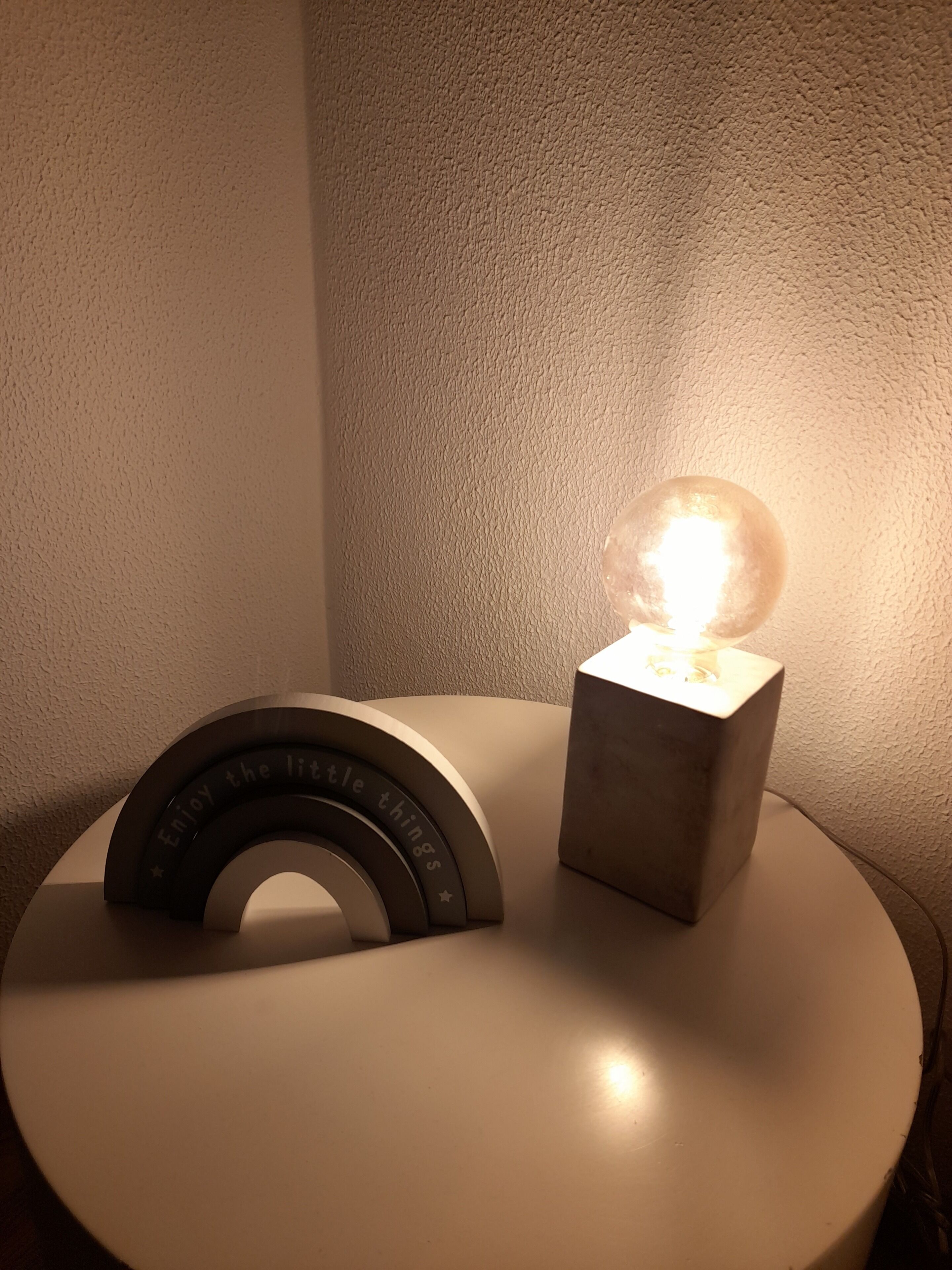 A round table with a clock and a light bulb on it.