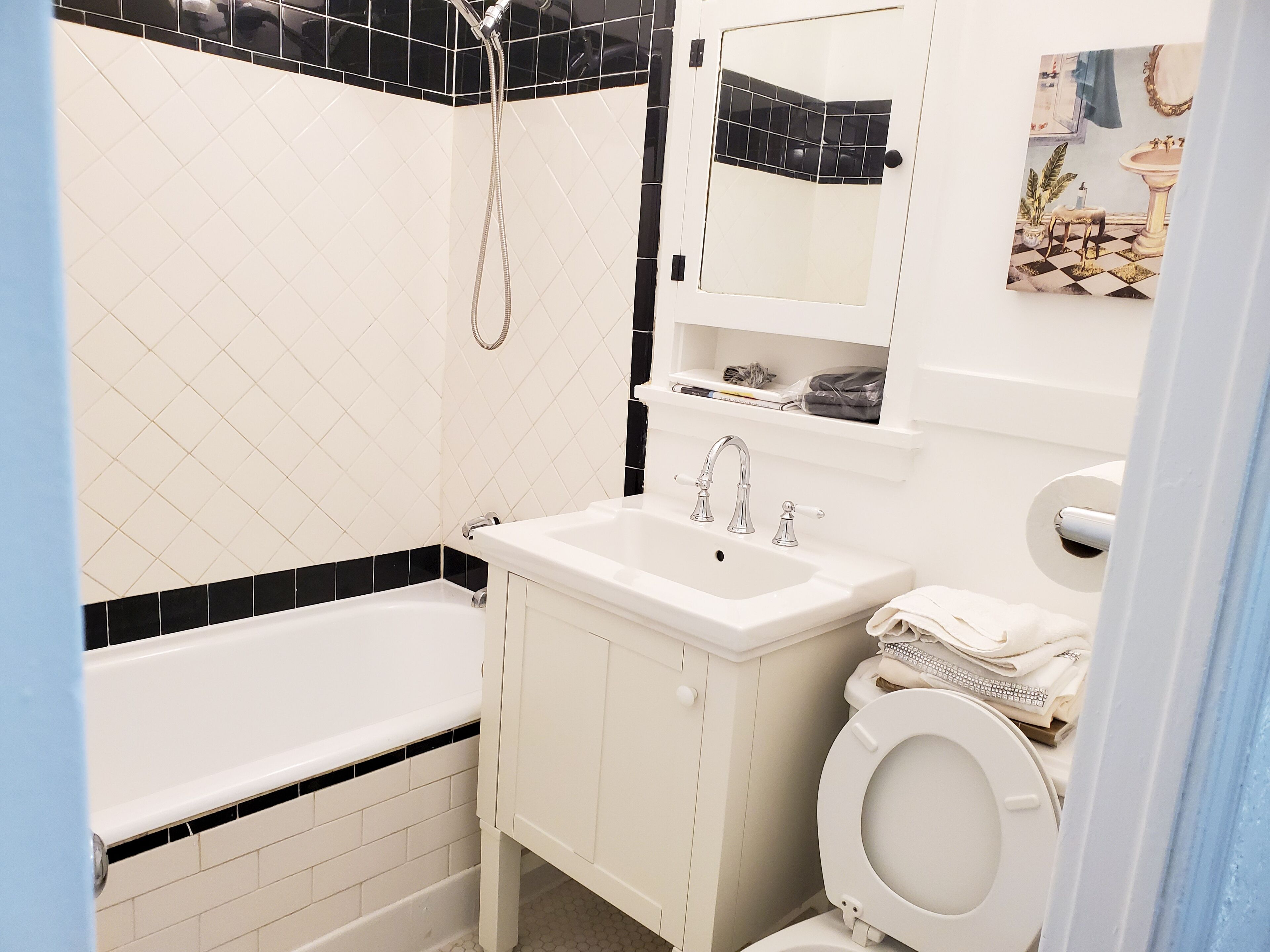 A bathroom with a bathtub, a sink, a toilet, and a shower.