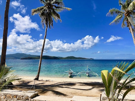 On the beach, white sand, sun loungers, scuba diving. Sunset Cove Beach & Dive Resort