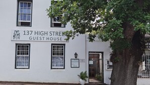 A white building with a sign reading "137 High Street Guest House." - 137 High Street Guest House (Makhanda)