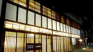 A building with traditional Japanese architecture, featuring sliding doors and a sign that reads "Mibu Juku". - Mibu-Juku (Kyoto)