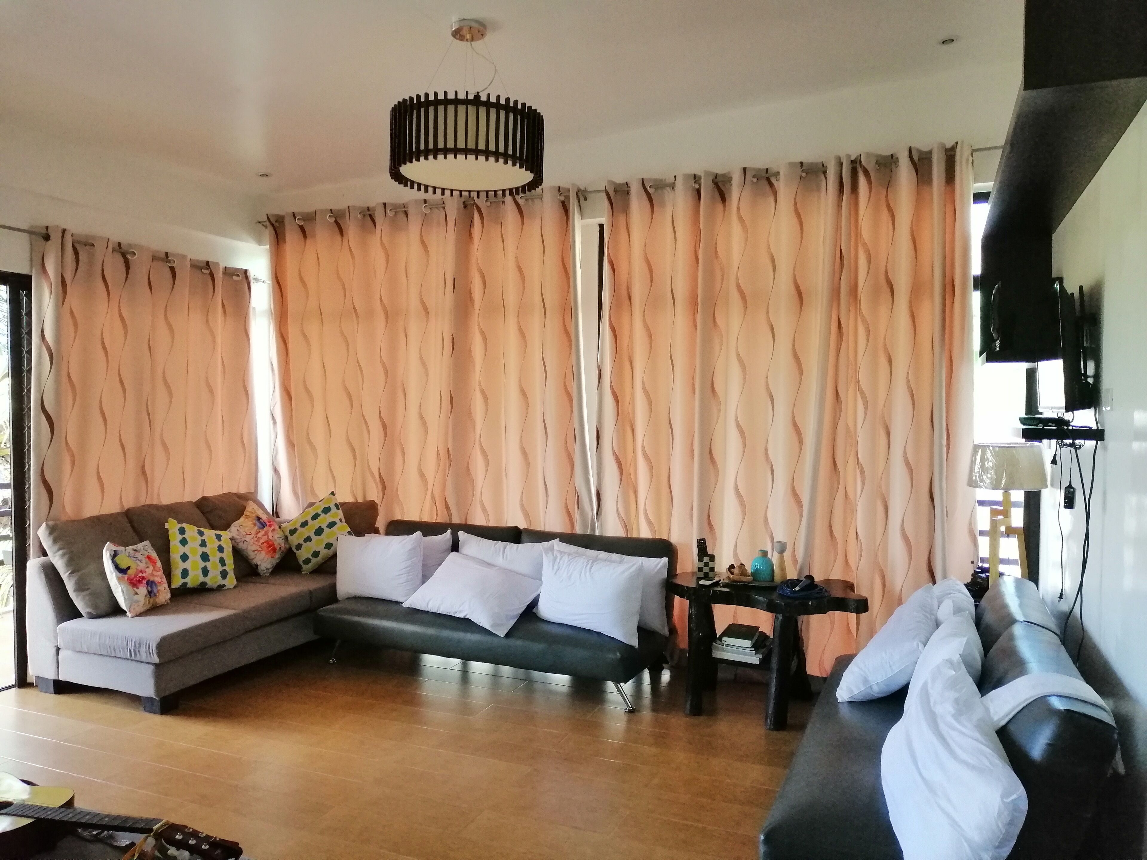 A living room with a sofa, a coffee table, and a television.