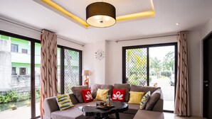 A modern living room with a sofa set, a coffee table, and a pendant light. - Casa Herminia Baler (Baler)