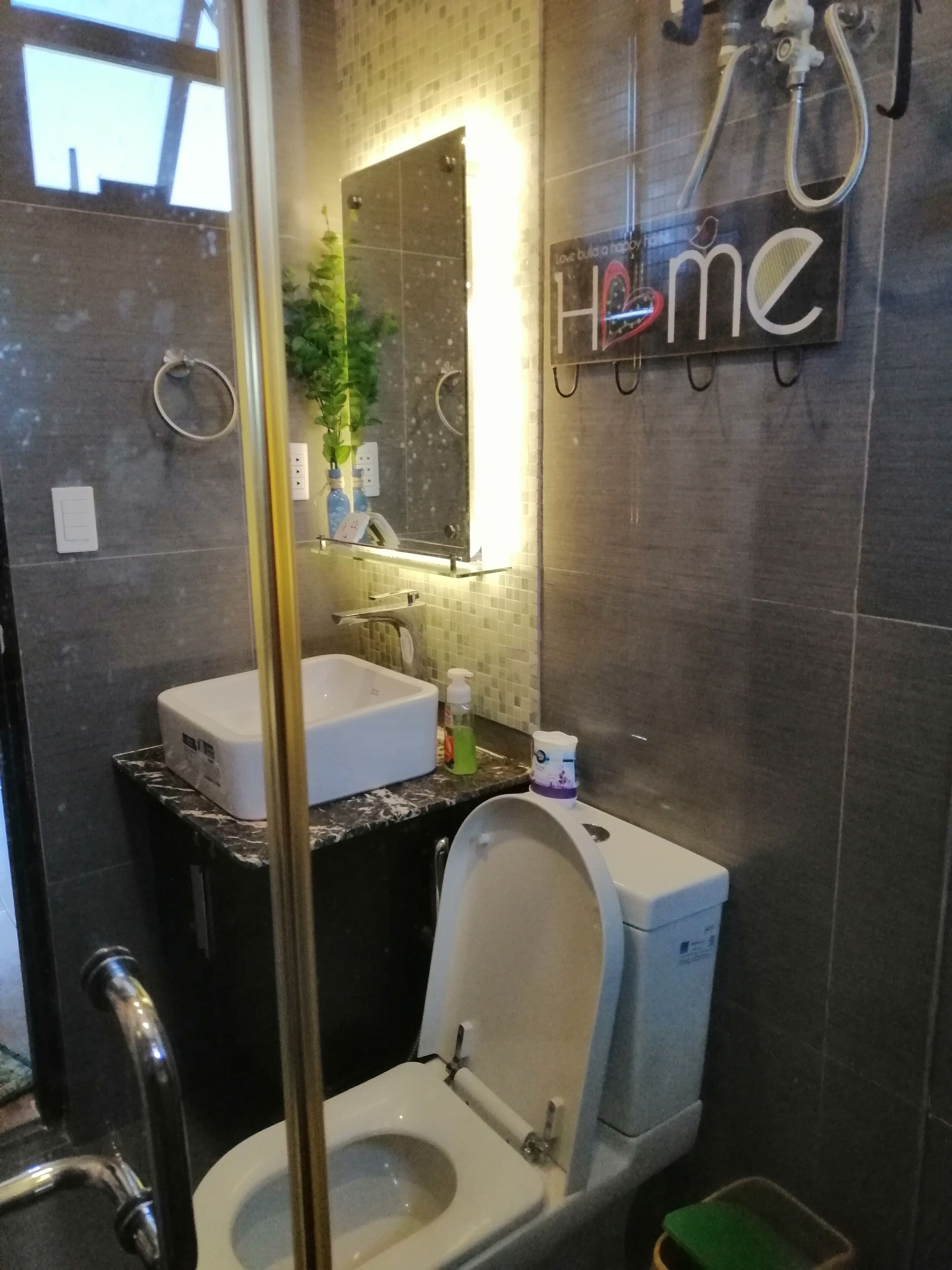 A modern bathroom with a toilet, sink, and shower.