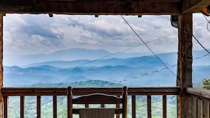A wooden deck with a view of a mountainous landscape. - Super View,Smoky Mtn Log Cabin,Pool Table,Hot Tub (Sevierville)