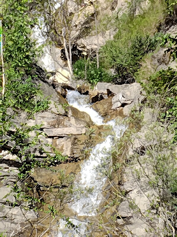 A natural rocky landscape with a small waterfall.
