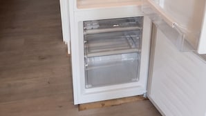 An open refrigerator with multiple shelves and a freezer compartment. - Homerez - Studio in Allos - mountain view (Allos)