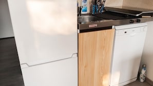 A kitchen with a dishwasher, a wooden cabinet, and a bottle of dish soap. - Homerez - Studio in Allos - mountain view (Allos)