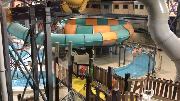 A water park with various water slides and a pool area. - Year round family fun (New Era)