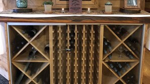 A wooden bar area with a framed poster, a small sign, and a vase of flowers. - Year round family fun (New Era)
