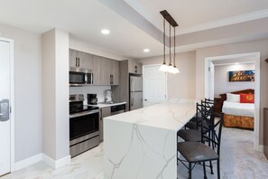 Enjoy meal preparation and dining in the spacious kitchen with a large island and adjacent dining area.