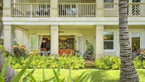 A two-story building with a covered front porch, a dining area, and a view of the surrounding greenery. - 3BR/3BA Villa, Central A/C, Resort Style Complex, 5 Minute Walk To Poipu Beach! (Koloa)