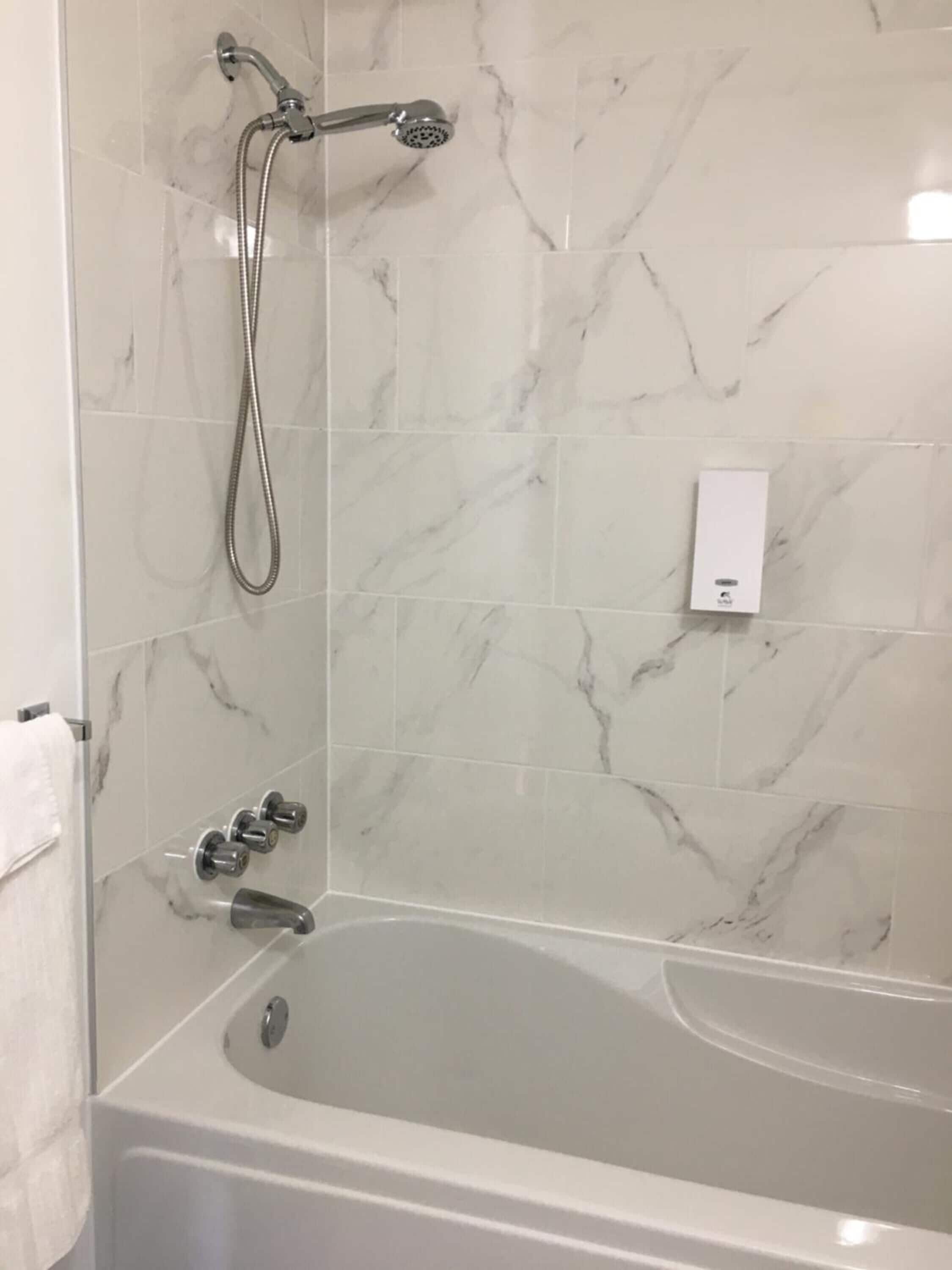 Combined shower/tub, hair dryer, towels, toilet paper