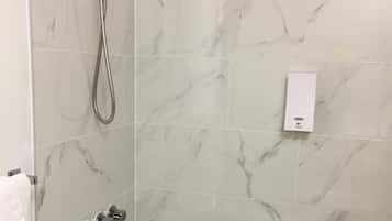 Combined shower/tub, hair dryer, towels, toilet paper