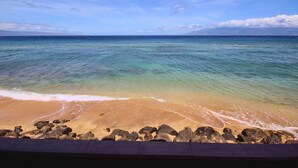 A beach with clear turquoise water and a sandy shore.