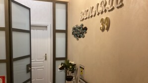 A hallway with a door, a welcome sign, and a wall with the number 39. - B&B Binario 39 (Naples)