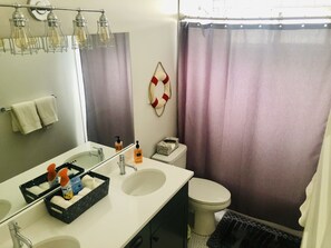 Bathtub, hair dryer, towels, soap