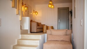 A staircase leading to a living area with a sofa and a lamp. - VILLA AGAPITOS (naxos)