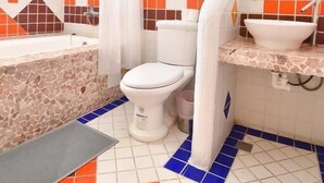 Un baño con bañera, inodoro y lavamanos.