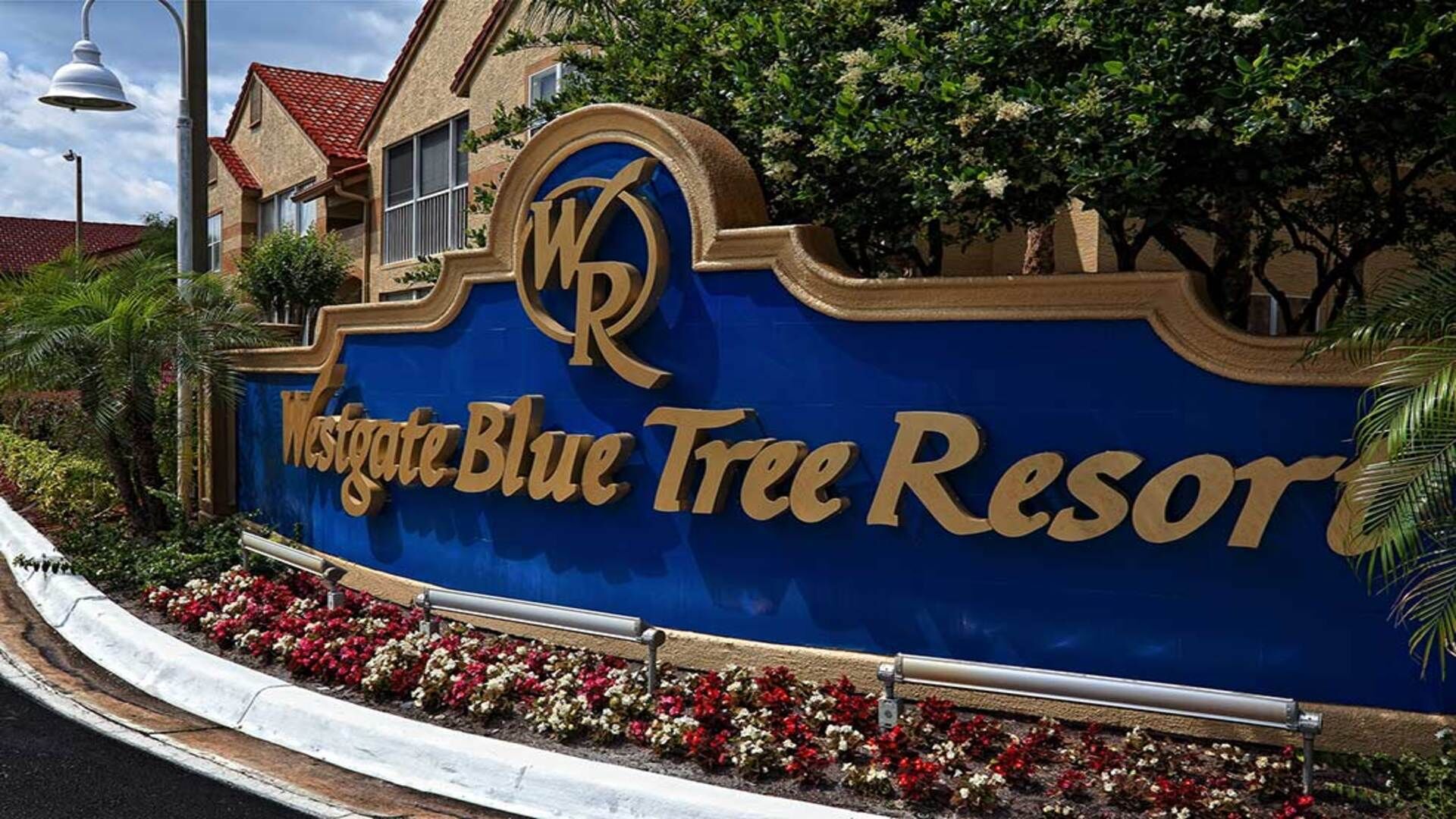 A sign for Westgate Blue Tree Resort with a prominent logo and the resort name.