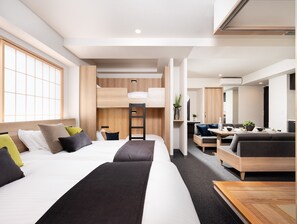 A modern hotel room with a large bed, a desk, a sofa, and a bunk bed. - MIMARU Tokyo Ueno Okachimachi (Tokyo)