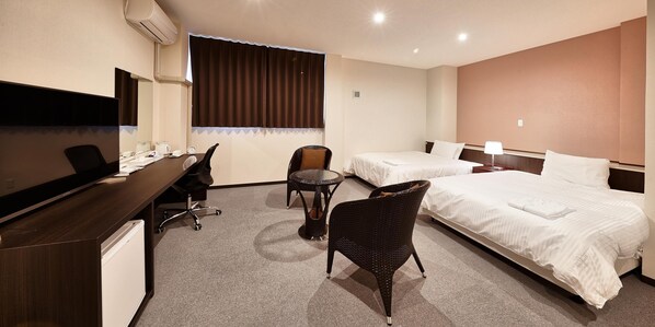 A hotel room with a desk, two single beds, a chair, and a large window with curtains. - Crown Hotel Okinawa Annex (Okinawa)