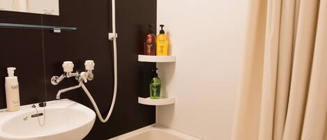 A bathroom with a white sink, a bathtub, and shelves holding toiletries.