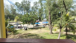 A view of a park with trees, a gazebo, and a building in the background. - Terengganu Equestrian Resort (Kuala Terengganu)