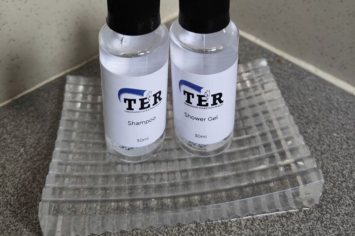 Two bottles of TER shampoo and shower gel on a clear tray.