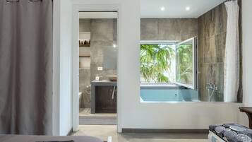 Deluxe Suite, 1 Queen Bed with Sofa bed, Garden View | Bathroom | Combined shower/tub, deep soaking tub, designer toiletries, hair dryer