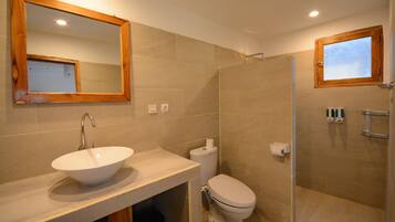 A bathroom with a sink, toilet, and shower.