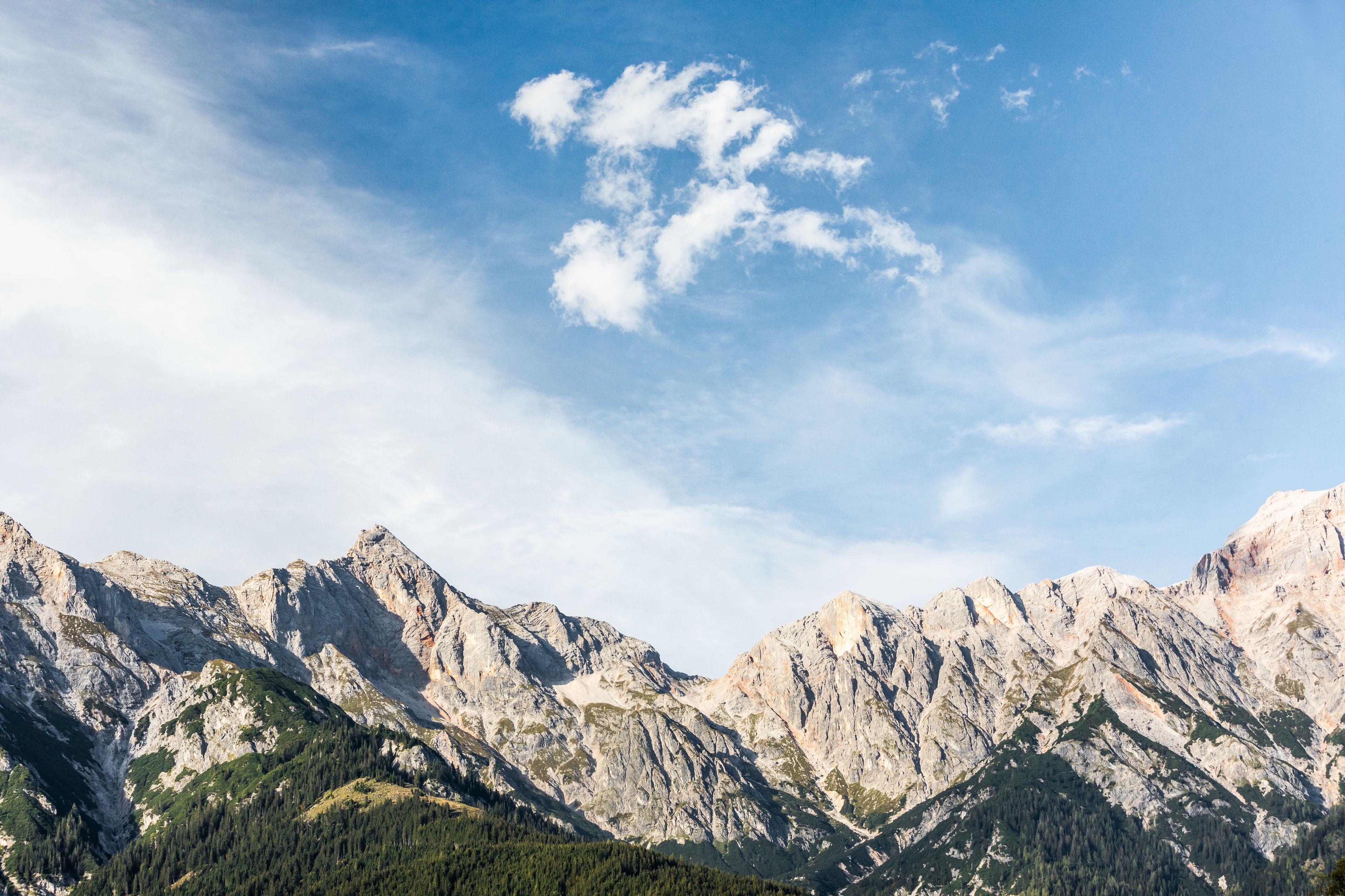 A mountainous landscape with rocky peaks and a clear sky.