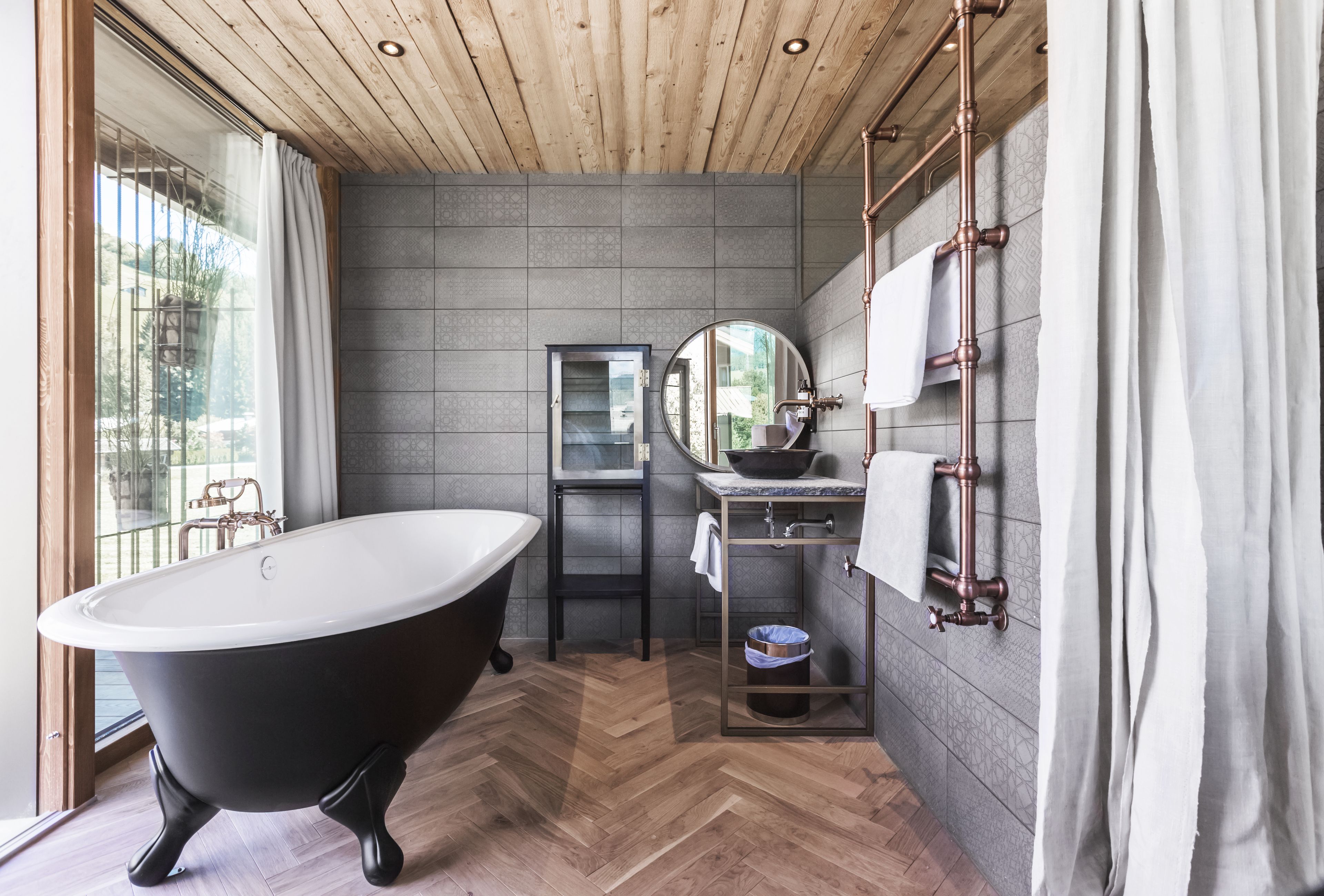 A modern bathroom with a freestanding bathtub, a vanity with a sink, and a mirror.