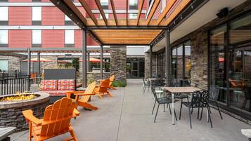 An outdoor patio area with seating and a fire pit.