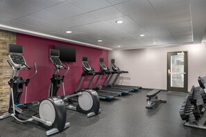 A gym with treadmills, ellipticals, and dumbbells. - Home2 Suites by Hilton Portland Hillsboro (Hillsboro)