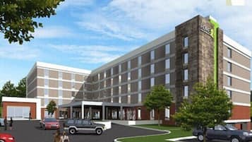 Stunning hotel building with a brick and glass facade, featuring a flat roof and multiple levels.