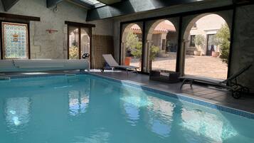 Indoor pool, open 9:00 AM to 9:00 PM, pool loungers