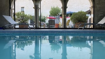 Indoor pool, open 9:00 AM to 9:00 PM, pool loungers