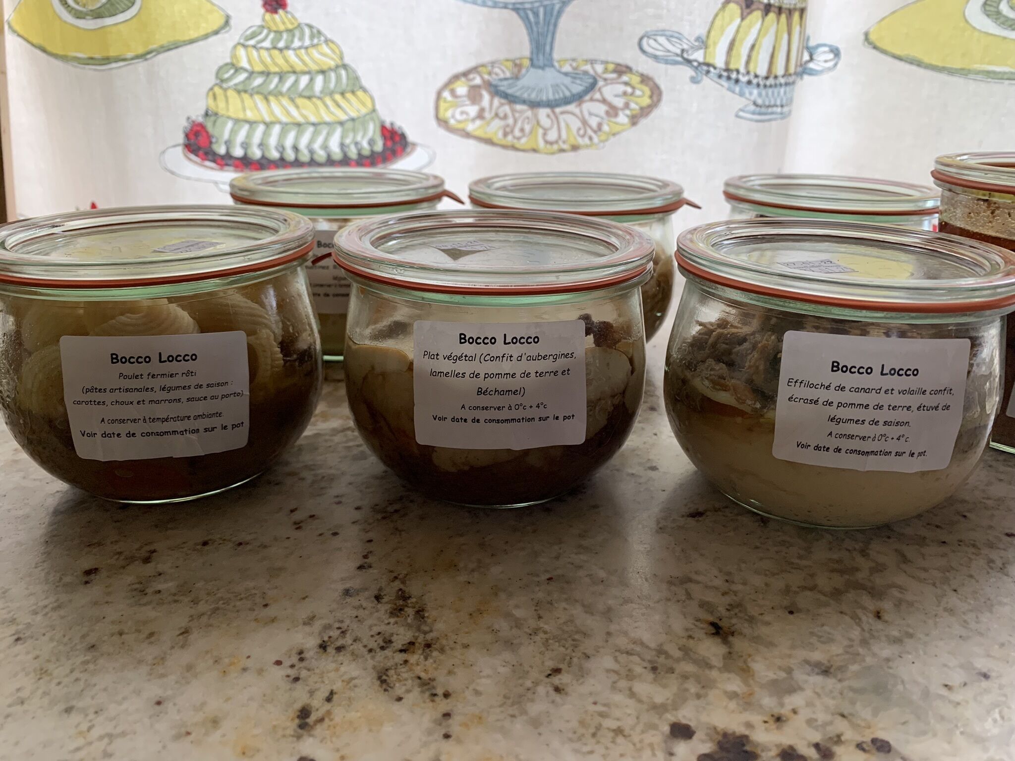 Several glass jars labeled 'Bocco Locco' containing preserved vegetables and meat, with instructions for storage and consumption.