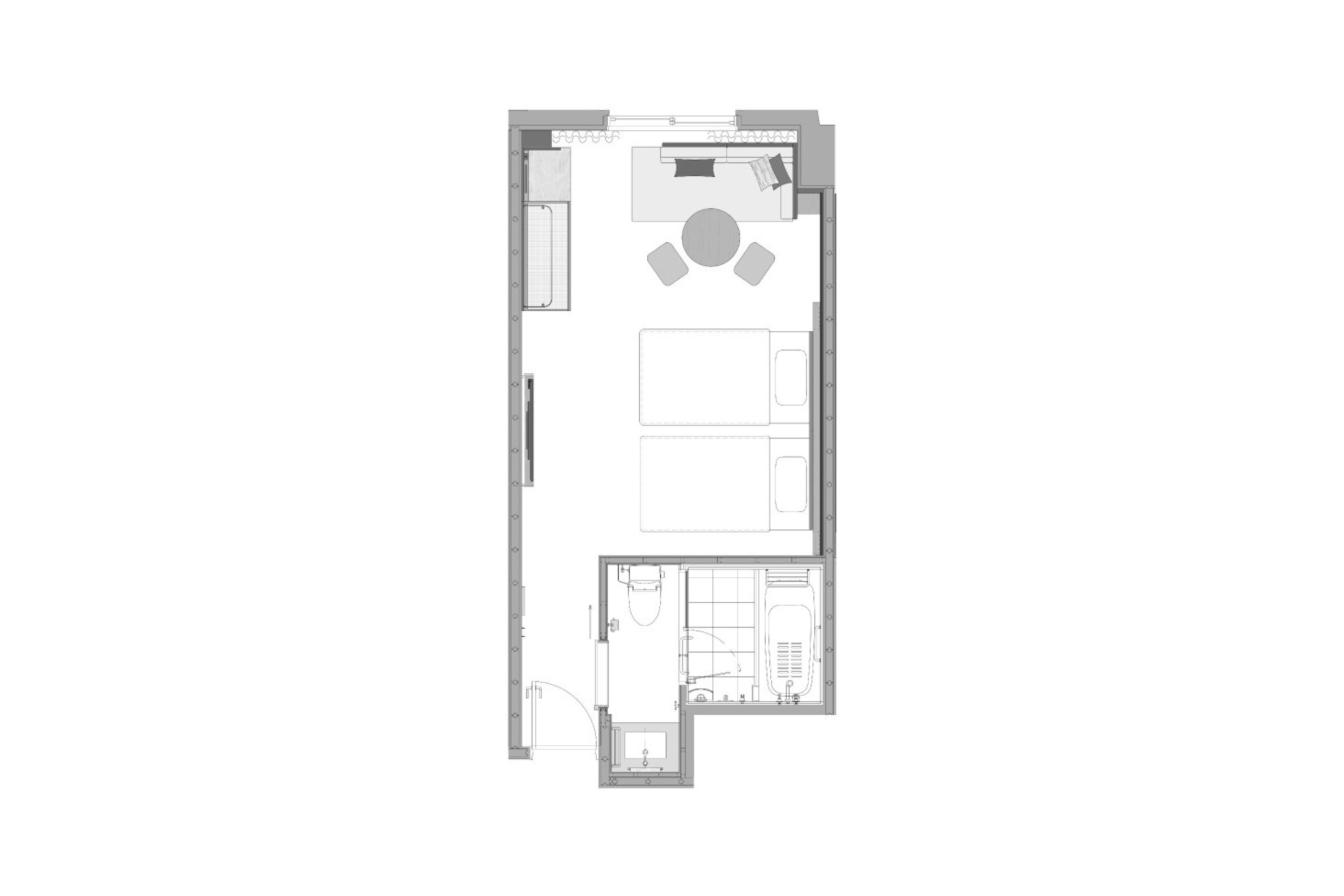 A floor plan of a hotel room with a bed, a desk, a chair, a small bathroom, and a seating area with a table and chairs.